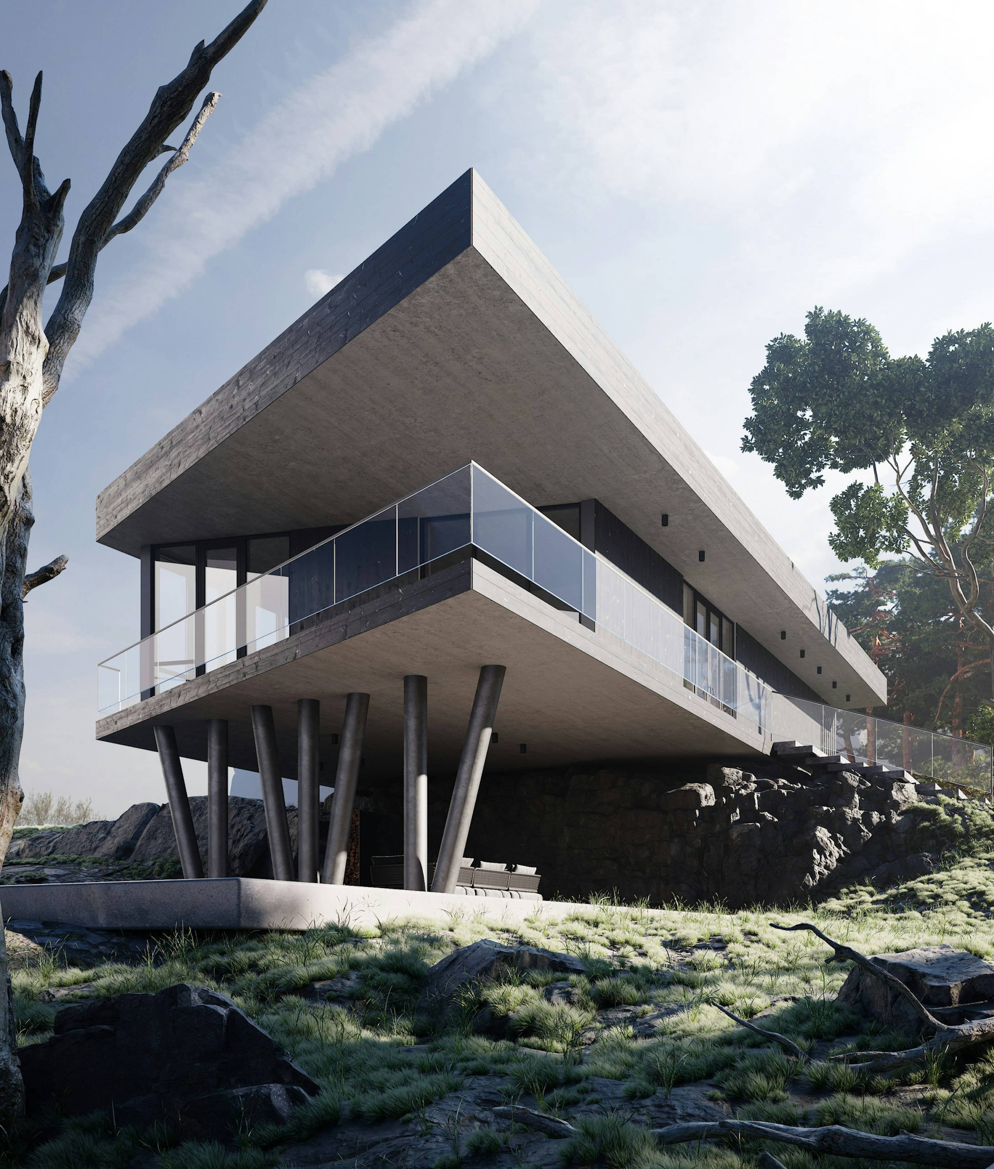 Casa de concreto em balanço sobre pilotis em meio a rochas e vegetação